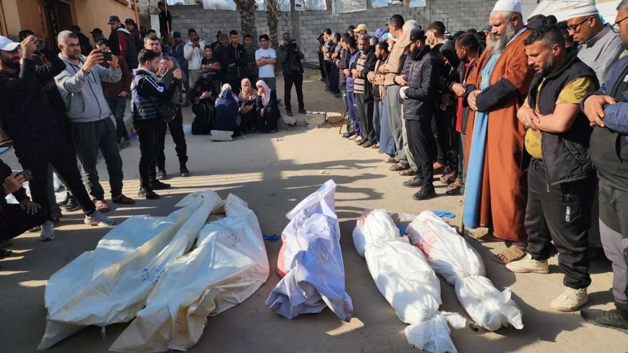 Bodies of Palestinians killed in renewed Israeli strikes are seen wrapped white sheets