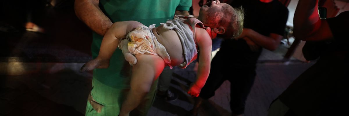 Body of baby killed in Israeli strike on Jabalia is brought to al-Ahli Baptist Hospital
