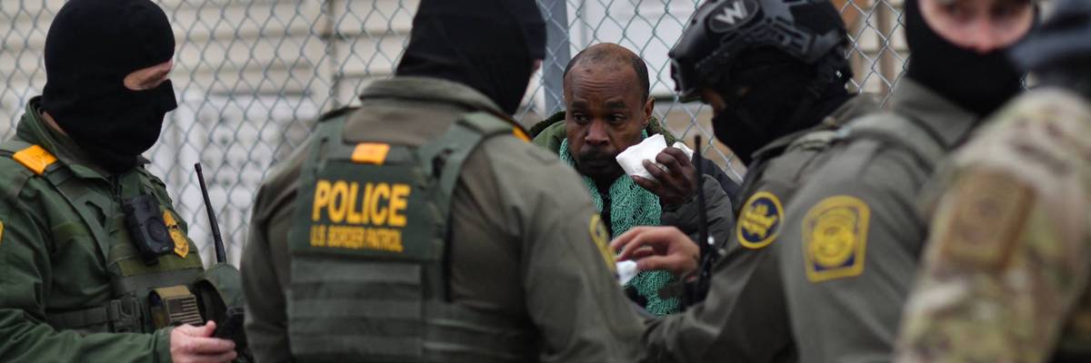 Border Patrol agents detain a man.