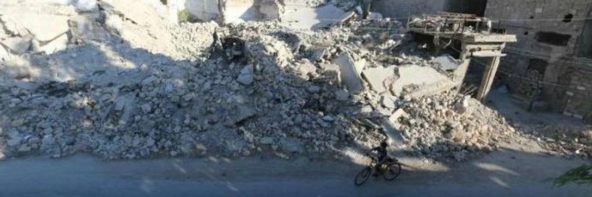 Boy in rubble in Syria.