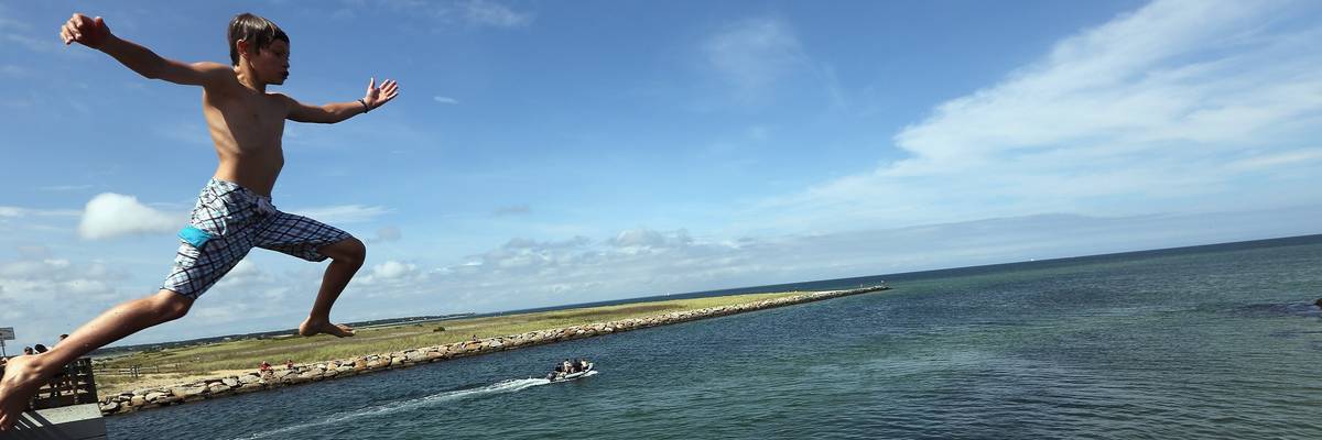 Boy jumps into ocean during 2012 JawsFest: The Tribute on Martha's Vineyard amidst increased shark sightings.