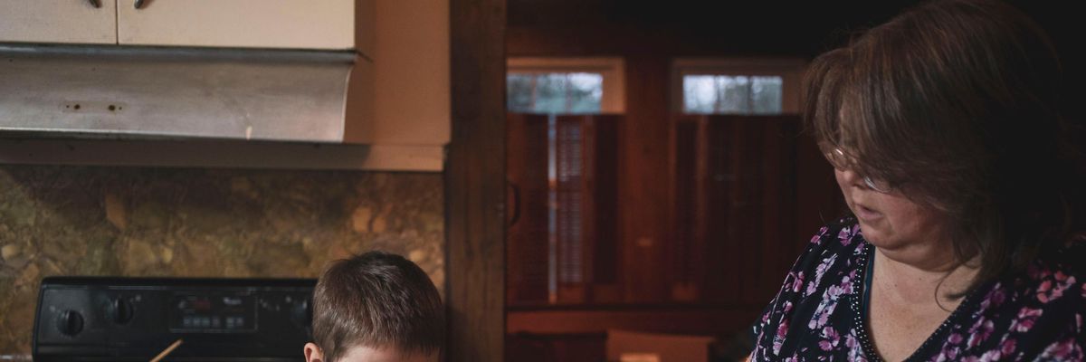 Boy makes dinner with his mother