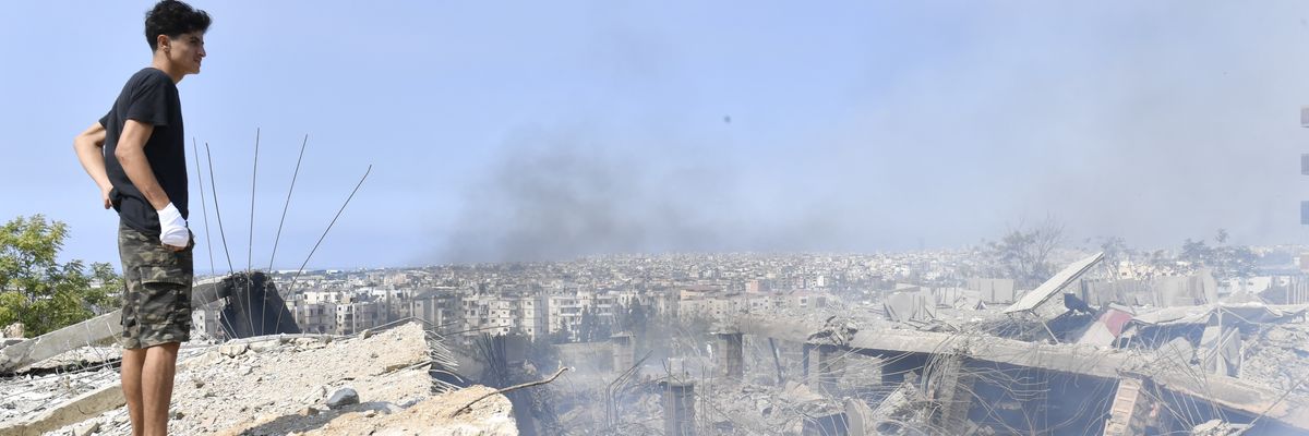 Boy overlooks damage of Israeli bombardment of Lebanon.