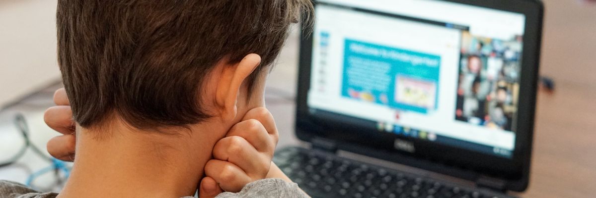Boy watching computer for online learning
