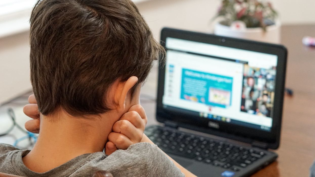 Boy watching computer for online learning