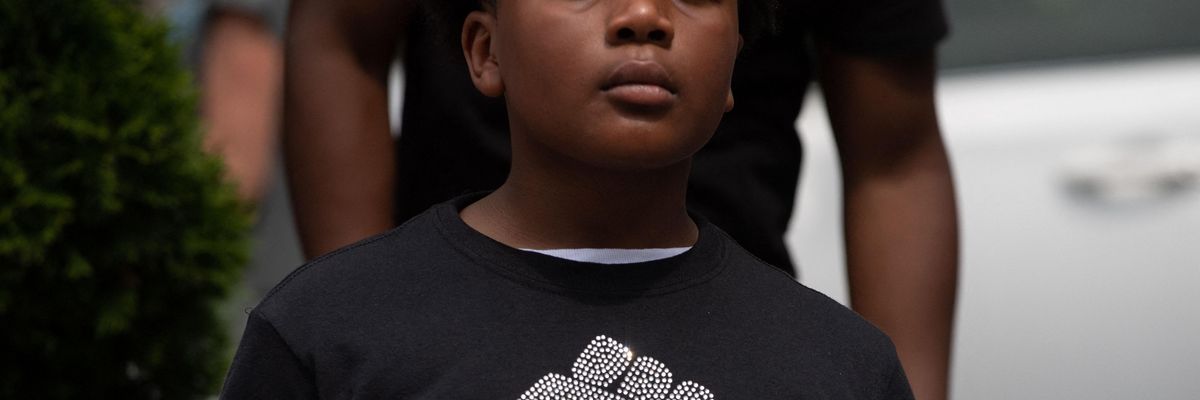 Boy wearing a t-shirt that reads "Juneteenth: Know Your History"