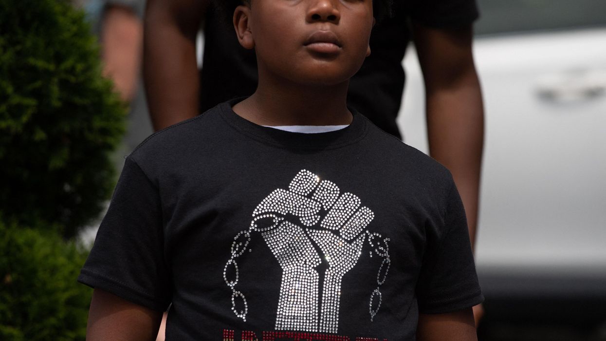 Boy wearing a t-shirt that reads "Juneteenth: Know Your History"
