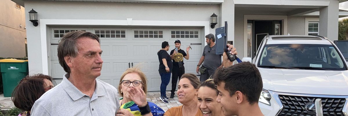 Brazil's far-right ex-president, Jair Bolsonaro, poses for photos with his supporters outside the Kissimmee, Florida home he is staying in on January 22, 2023.