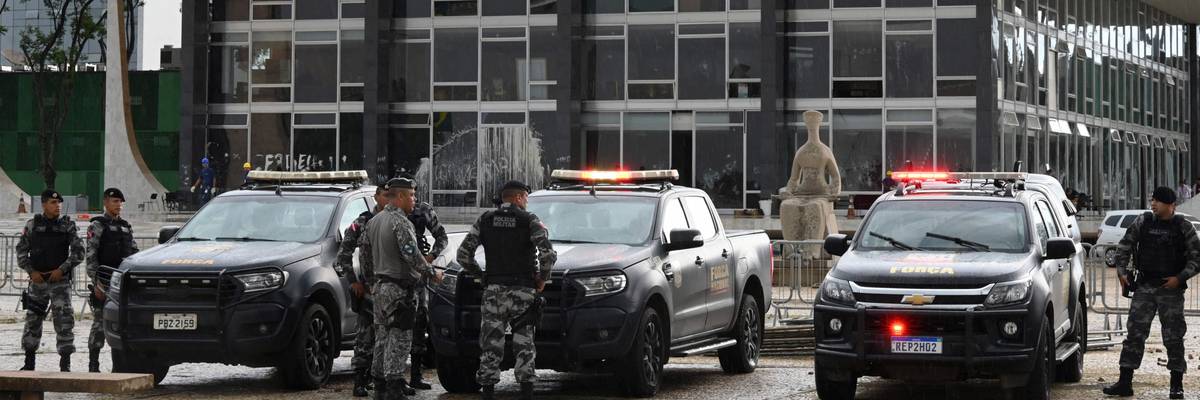Brazilian police officers stand guard outside the presidential palace