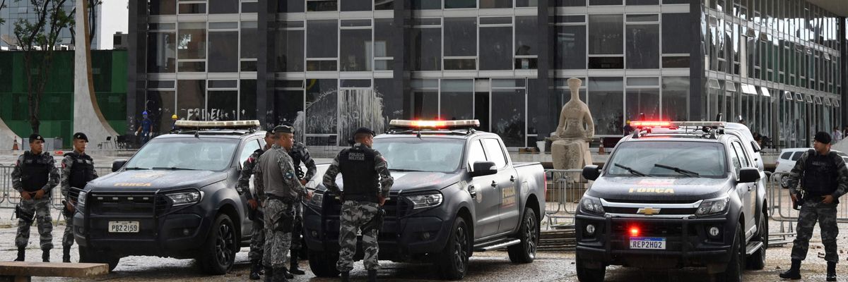 Brazilian police officers stand guard outside the presidential palace