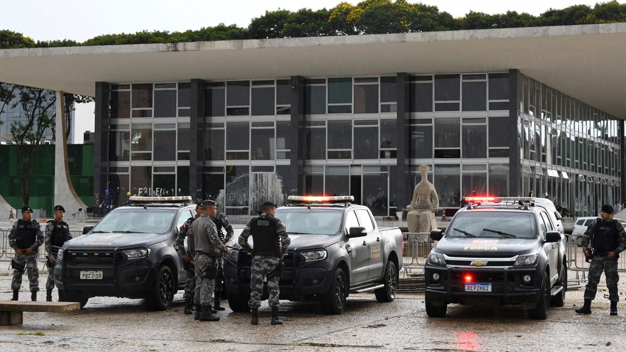 Brazilian police officers stand guard outside the presidential palace