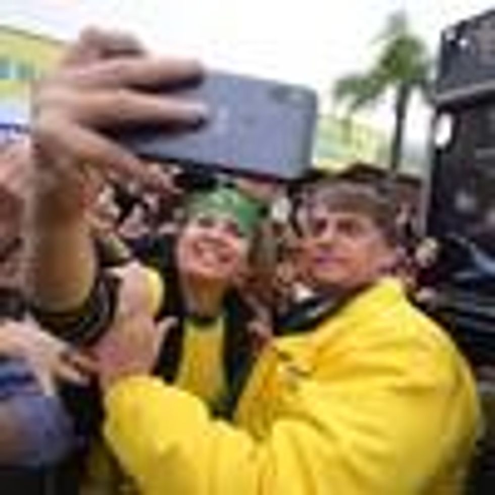 Brazilian President Jair Bolsonaro takes a selfie with a supporter