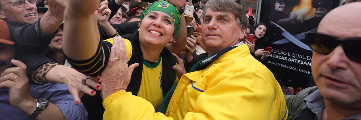 Brazilian President Jair Bolsonaro takes a selfie with a supporter