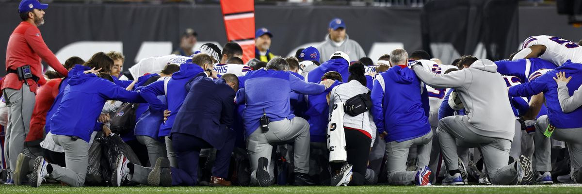 Buffalo Bills players and staff kneel together 