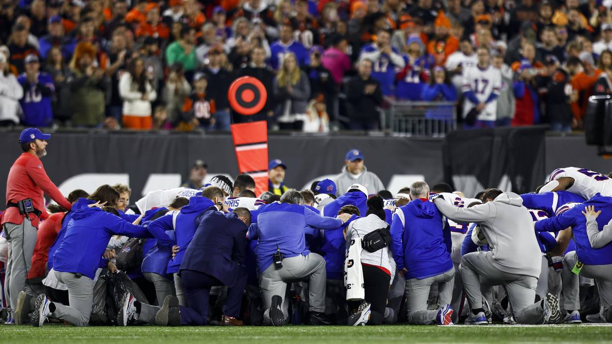 Buffalo Bills players and staff kneel together