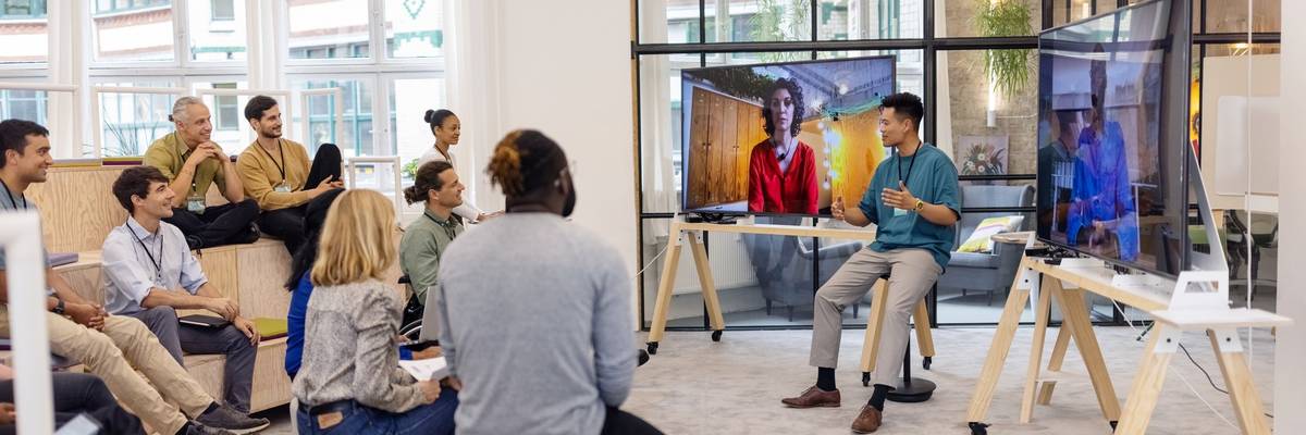 Business people having hybrid meeting in office