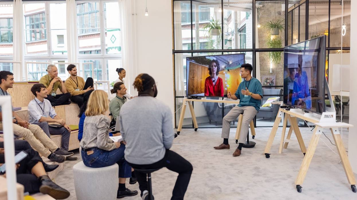 Business people having hybrid meeting in office