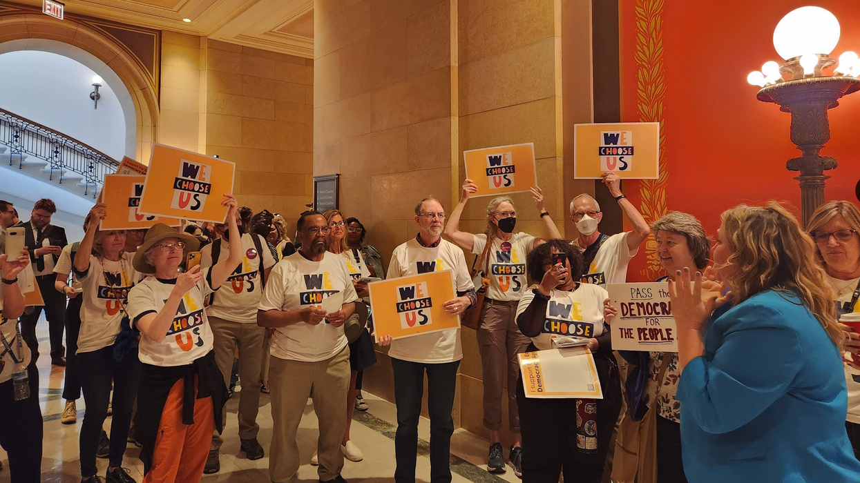 Campaigners with We Choose Us celebrate the passage of the Democracy for the People Act