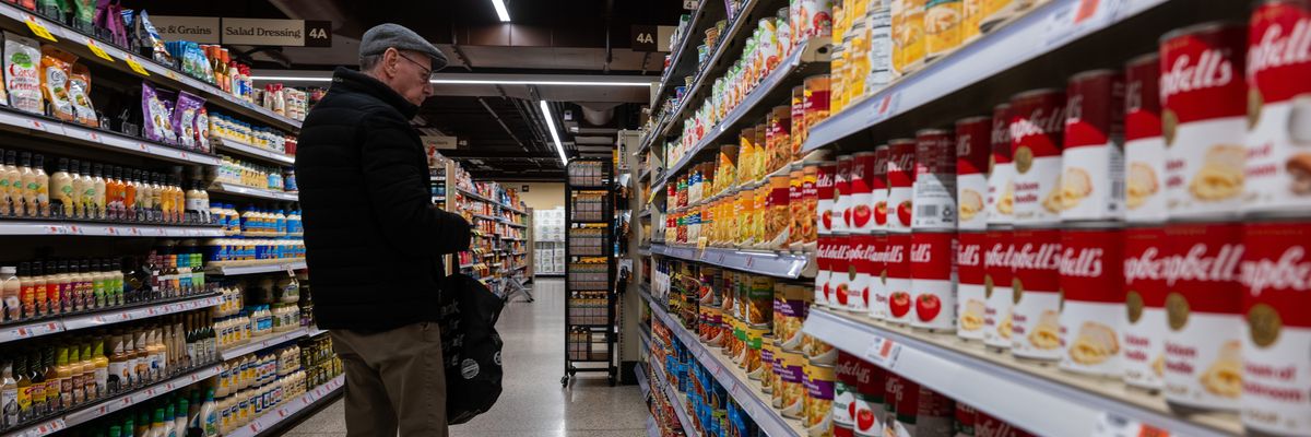 Canned soup and vegetables are displayed in a grocery store