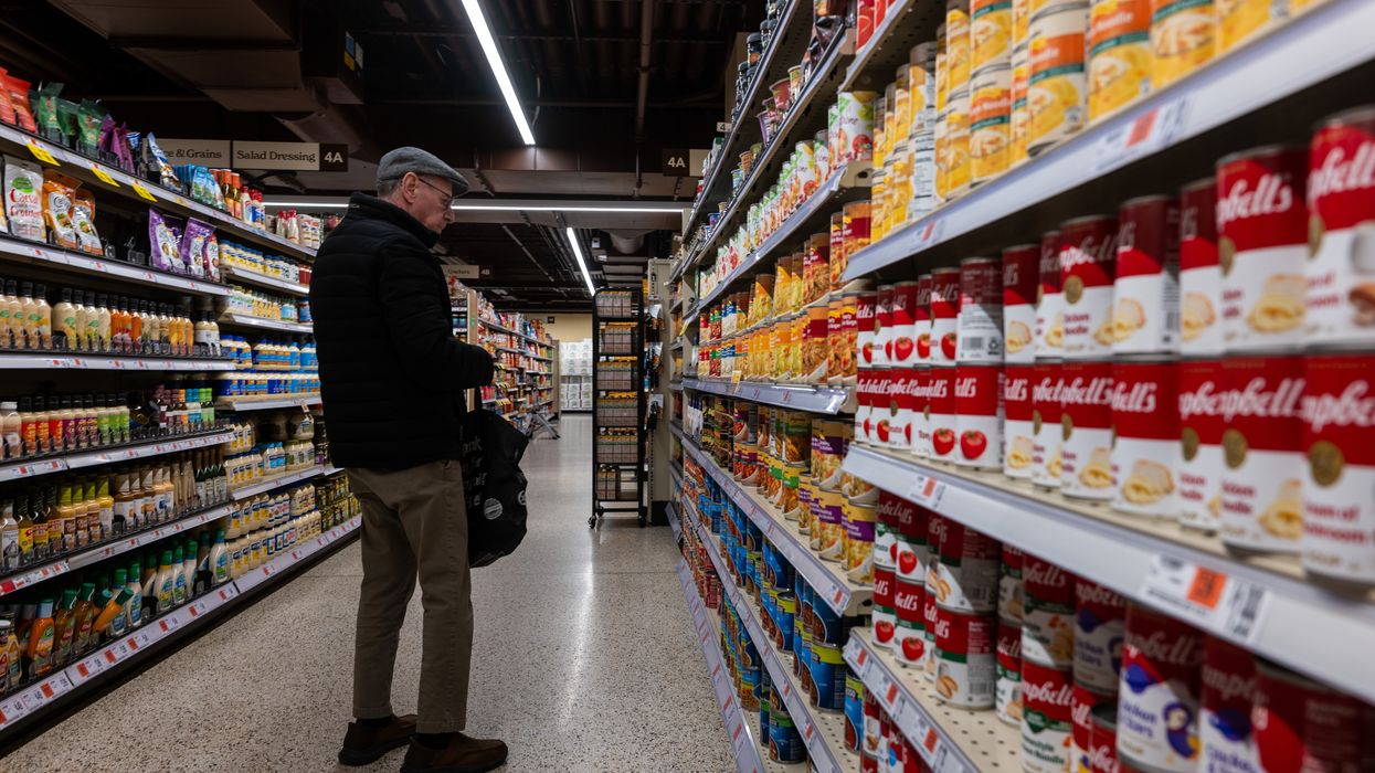 Canned soup and vegetables are displayed in a grocery store