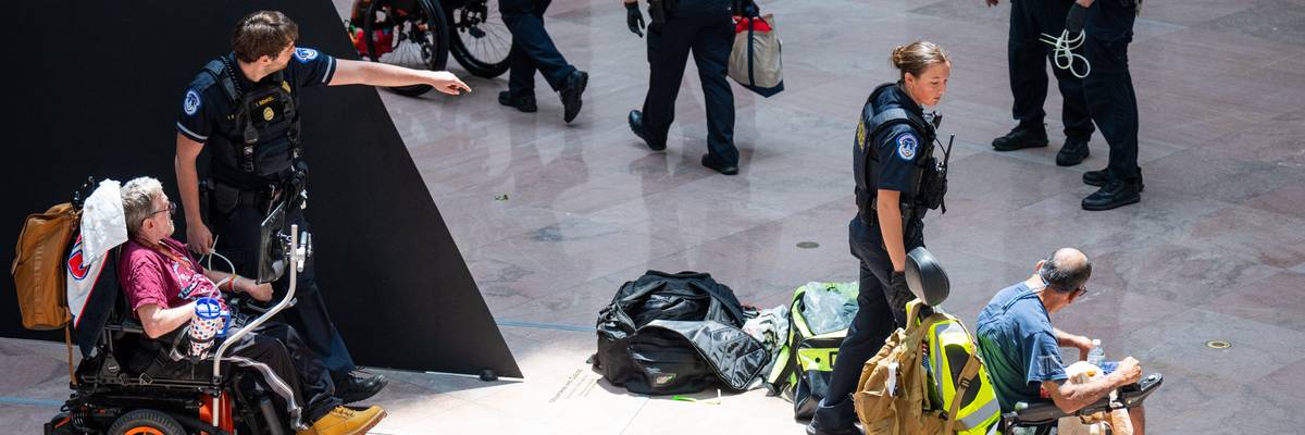 Capitol Police arrest protesters in wheelchairs.