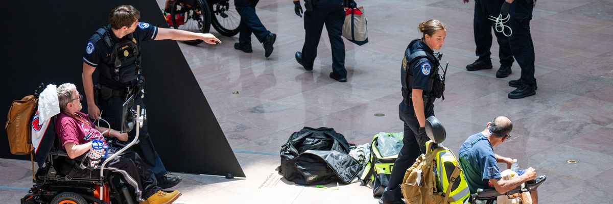 Capitol Police arrest protesters in wheelchairs.