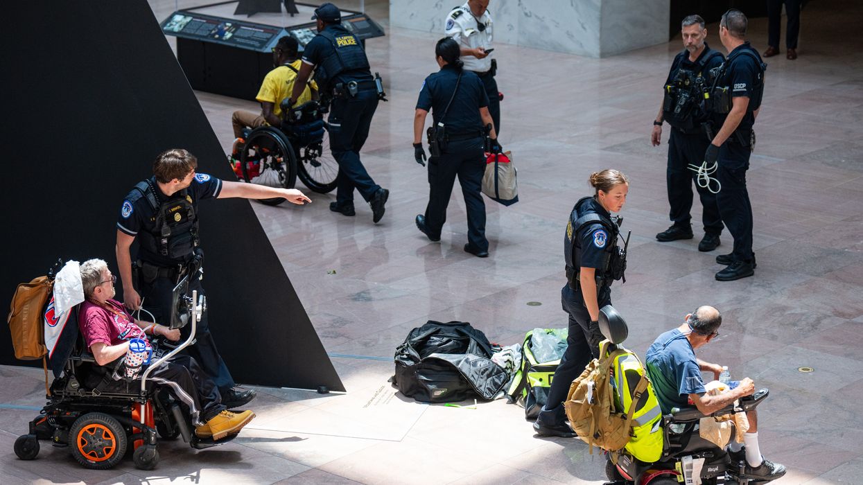 Capitol Police arrest protesters in wheelchairs.