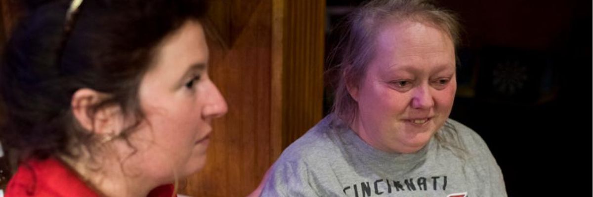 Cara Stewart, a legal advocate opposing Medicaid work requirements, comforts Pauline Creech in Covington, Kentucky