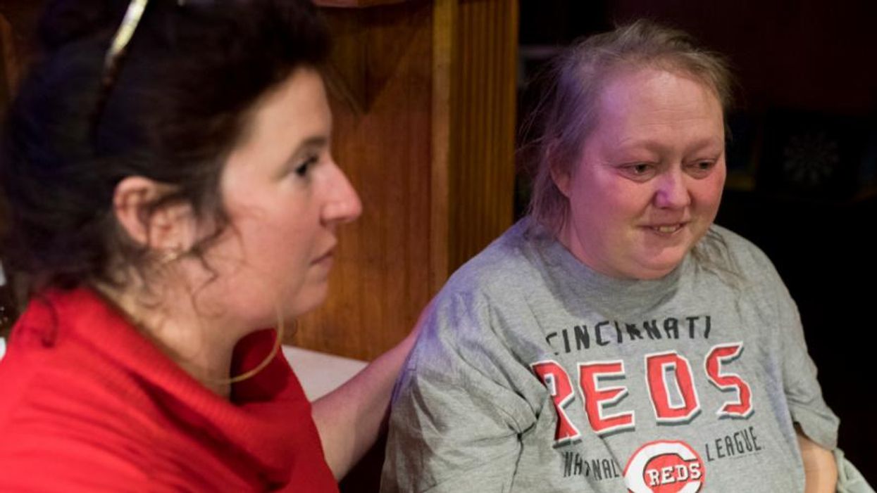 Cara Stewart, a legal advocate opposing Medicaid work requirements, comforts Pauline Creech in Covington, Kentucky