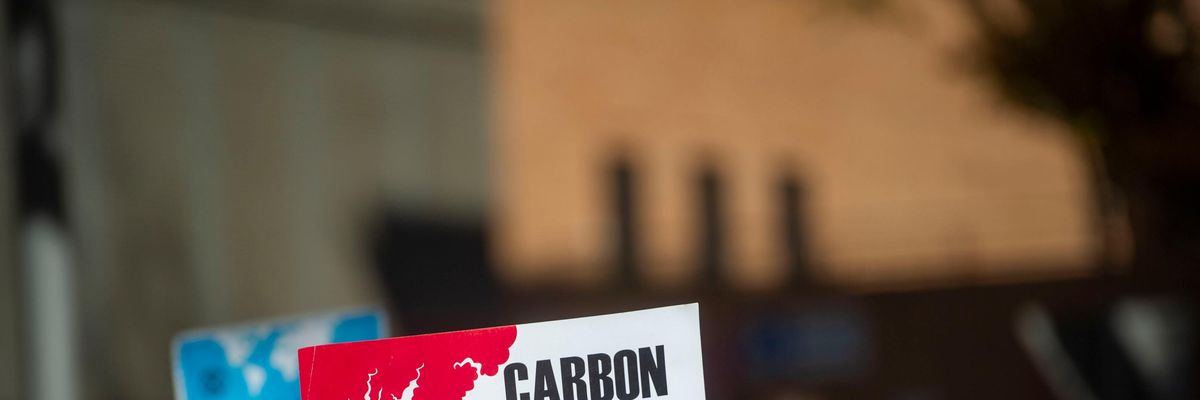 Carbon Capital Is Killing Us sign