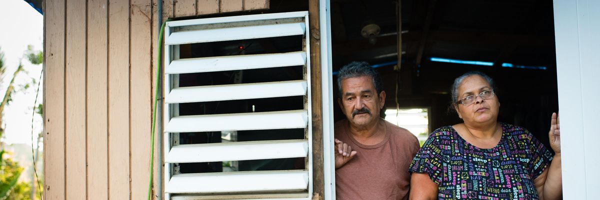 Carlos Fernandez and his wife, Ivette Garcia, stand in the doorway of their temporary house in Villalba, Puerto Rico on August 27, 2018, one year after Hurricane Maria destroyed their home.