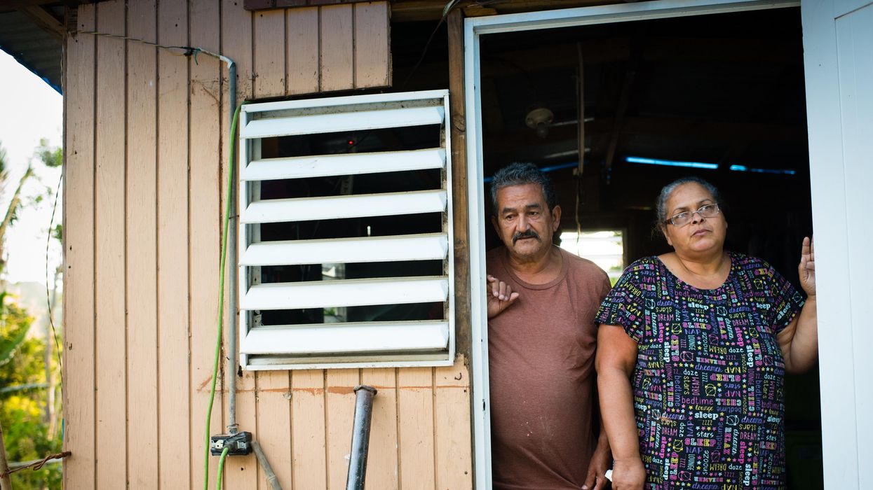 Carlos Fernandez and his wife, Ivette Garcia, stand in the doorway of their temporary house in Villalba, Puerto Rico on August 27, 2018, one year after Hurricane Maria destroyed their home.