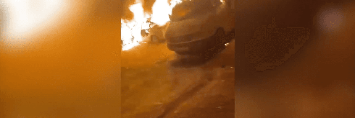 Cars are seen burning in the West Bank town of Sinjil