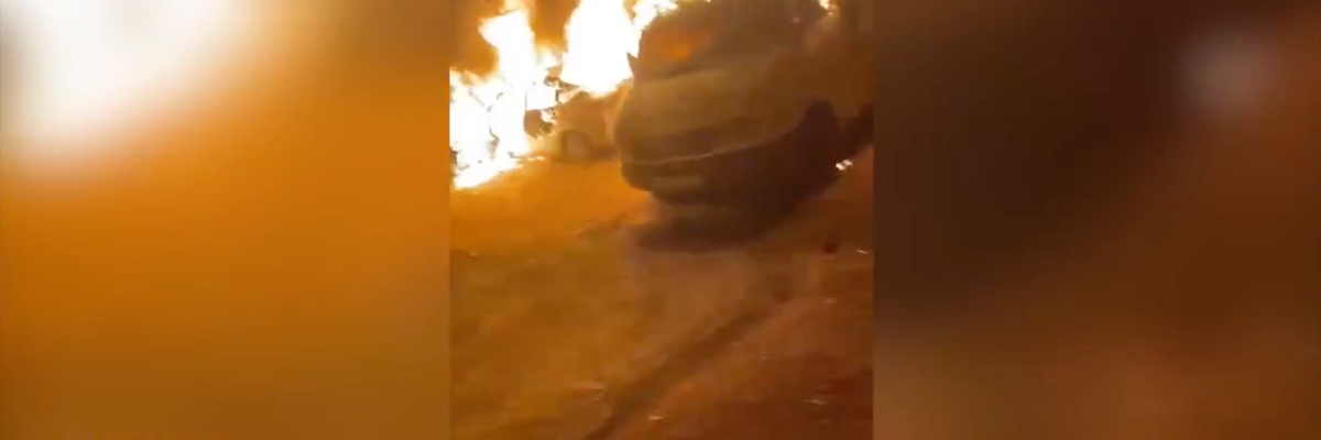 Cars are seen burning in the West Bank town of Sinjil