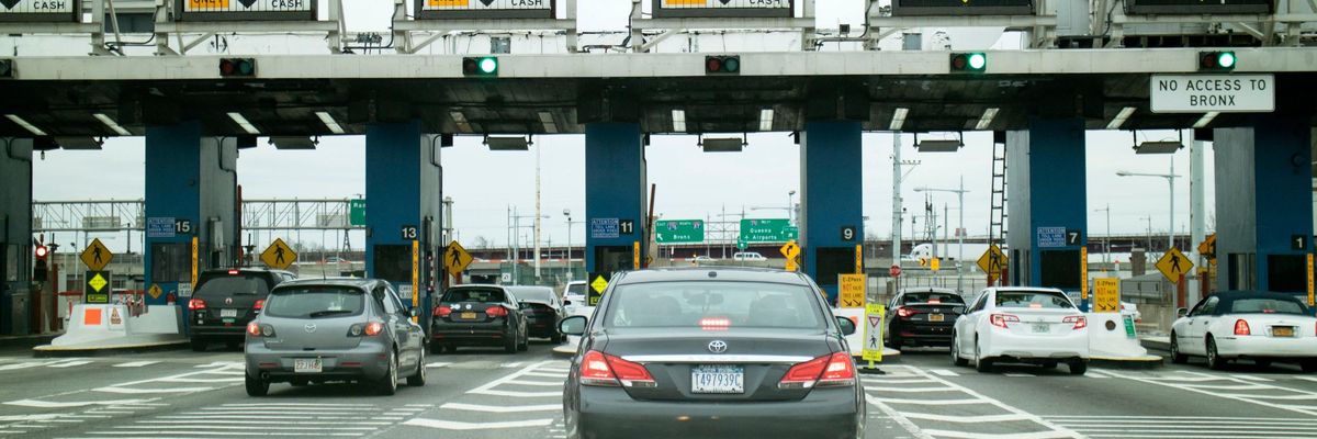 cars wait at a toll plaza