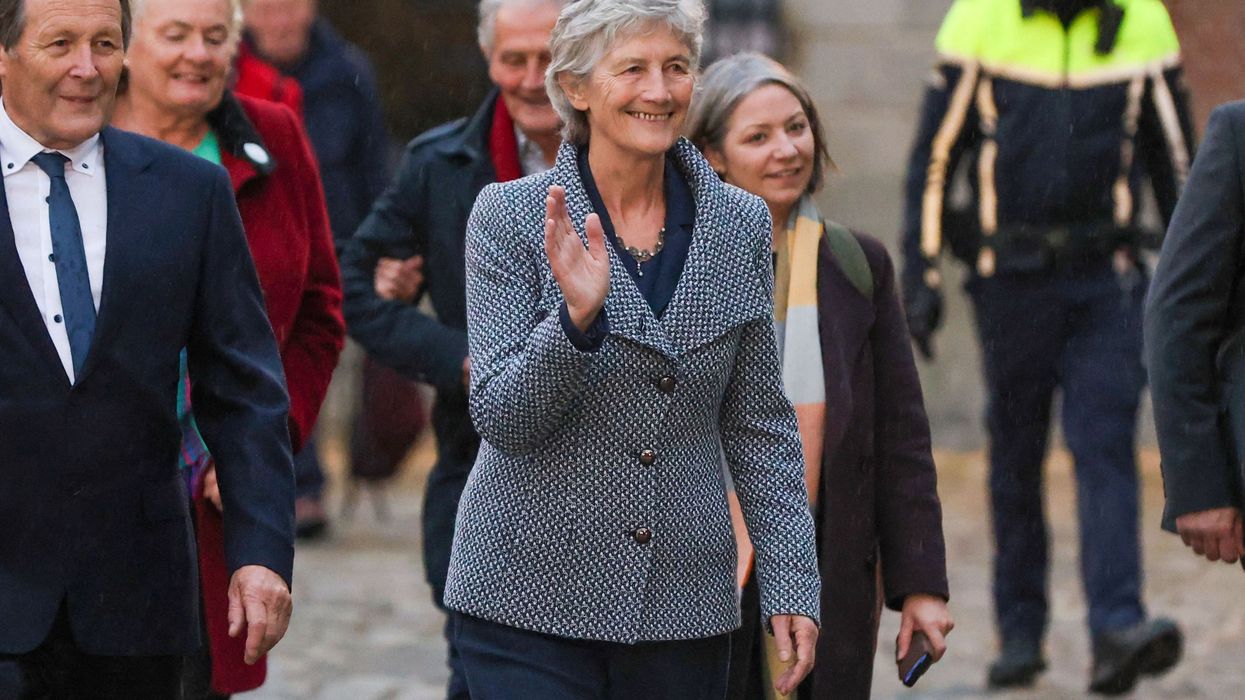 Catherine Connolly waves after winning Irish election.