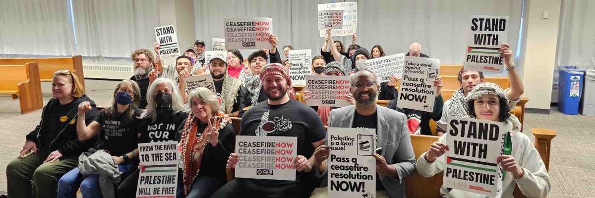 Cease-fire supporters hold signs.