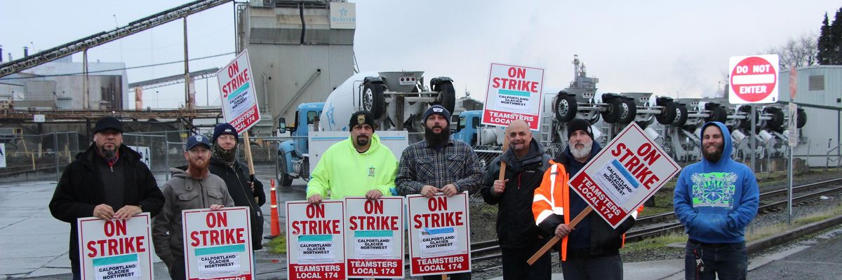 Cemeter workers and members of Teamsters Local 174 stand at the picket line.