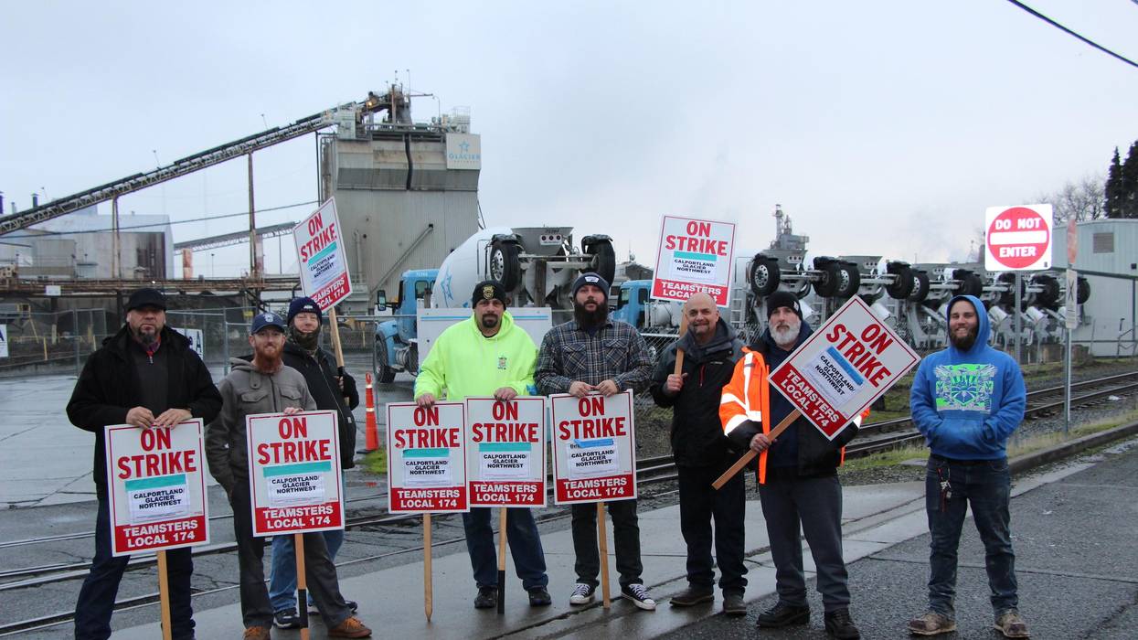 Cemeter workers and members of Teamsters Local 174 stand at the picket line.