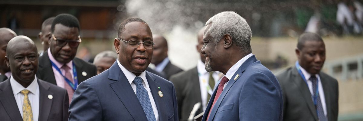Chairperson of the African Union Commission Moussa Faki Mahamat (R) receives Senegalese President Macky Sall (C) at the Africa Climate Summit 2023
