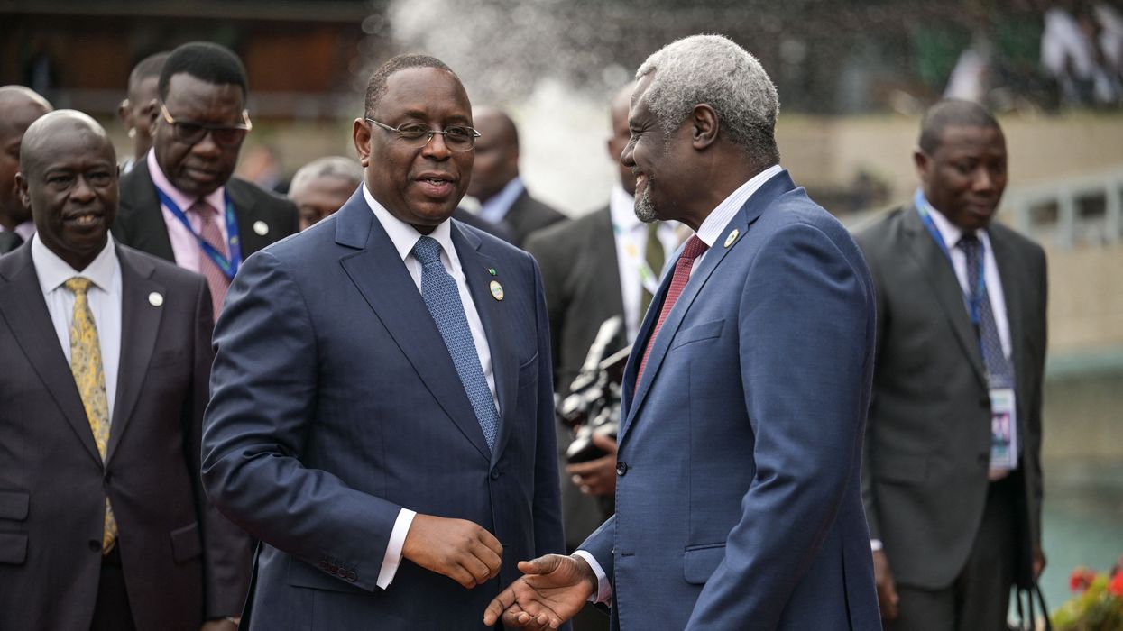 Chairperson of the African Union Commission Moussa Faki Mahamat (R) receives Senegalese President Macky Sall (C) at the Africa Climate Summit 2023