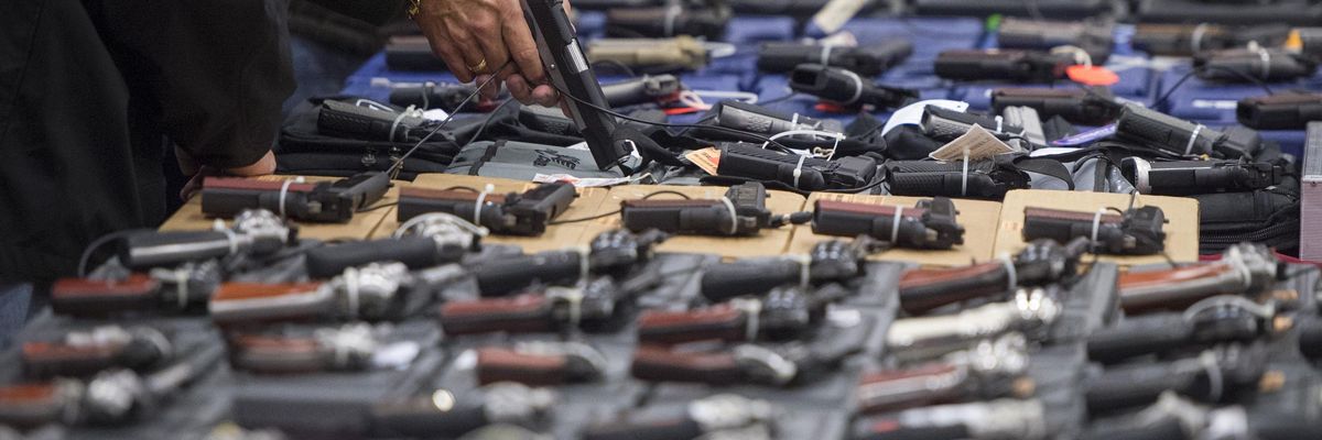 CHANTILLY, VA - OCTOBER 3: People look at handguns as thousands of customers and hundreds of dealers sell, show, and buy guns and other items during The Nation's Gun Show at the Dulles Expo Center which is the first major gun show in the area since the Oregon shooting in Chantilly, VA on Saturday, October 03, 2015. (Photo: Jabin Botsford/The Washington Post via Getty Images)