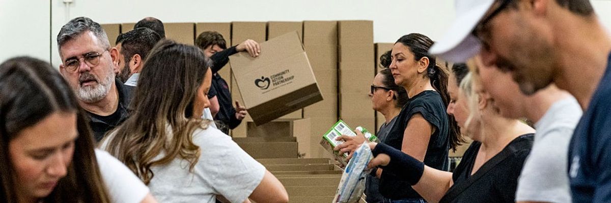 Charity workers pack boxes of food