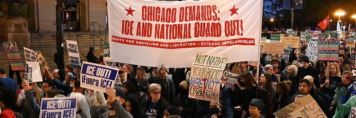 chicago protesters carry signs against ICE and National Guard deployments