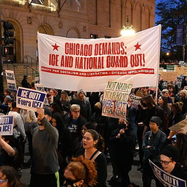 chicago protesters carry signs against ICE and National Guard deployments