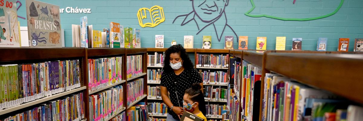 Child and woman in library
