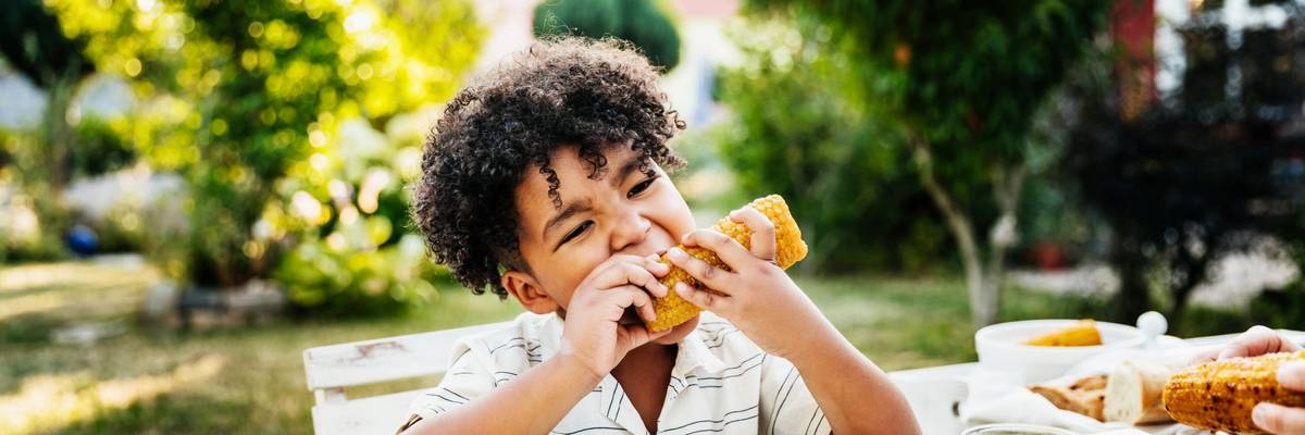 child eating corn