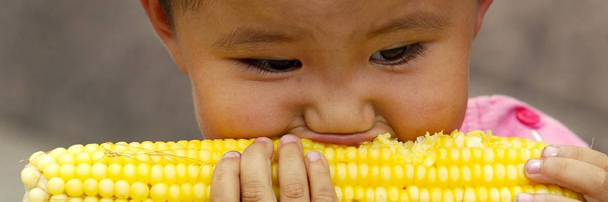 child eating corn