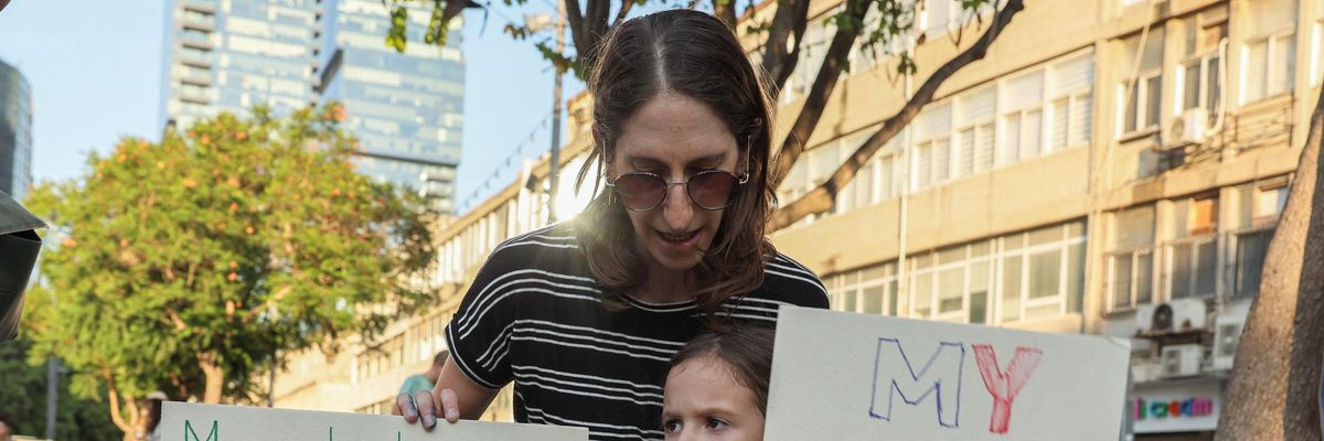 child holds protest sign