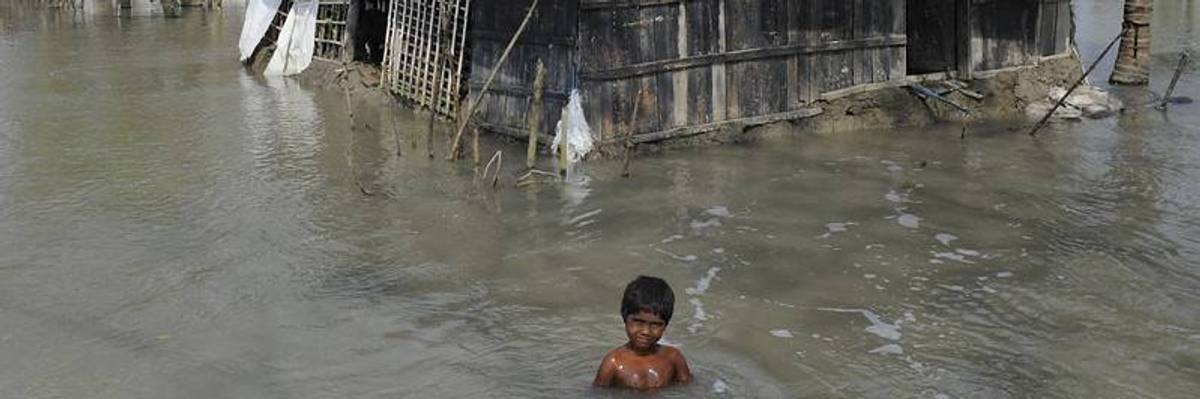 Child in floodwaters.